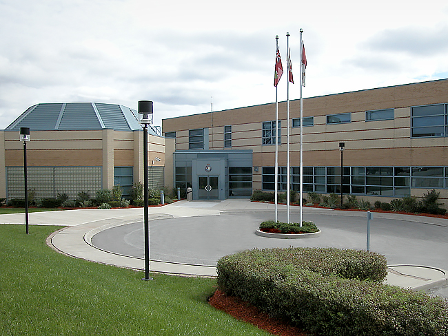 A building with three flags at full mast