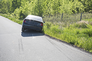 A car leans into a ditch