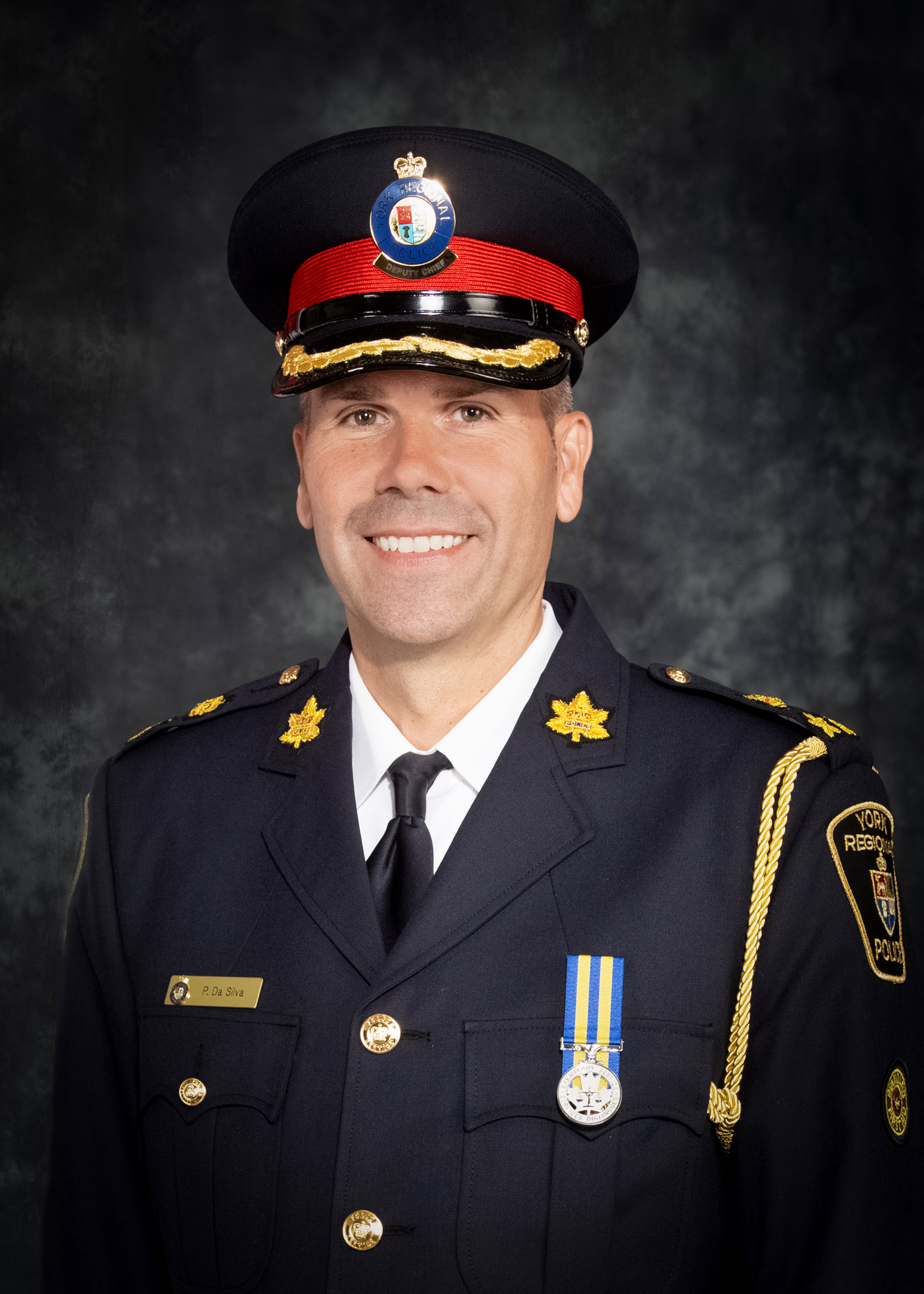 Man smiling wearing a police uniform