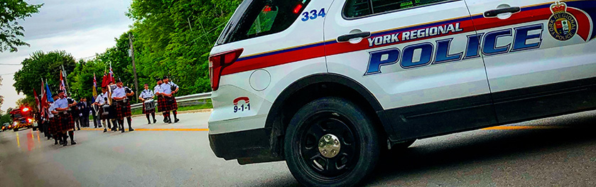 A picture of the band marching and a YRP cruiser in the foreground