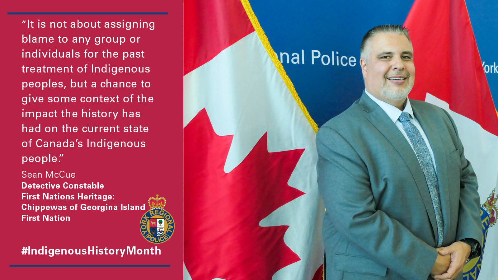 An officer in a suit in front of the YRP logo backdrop