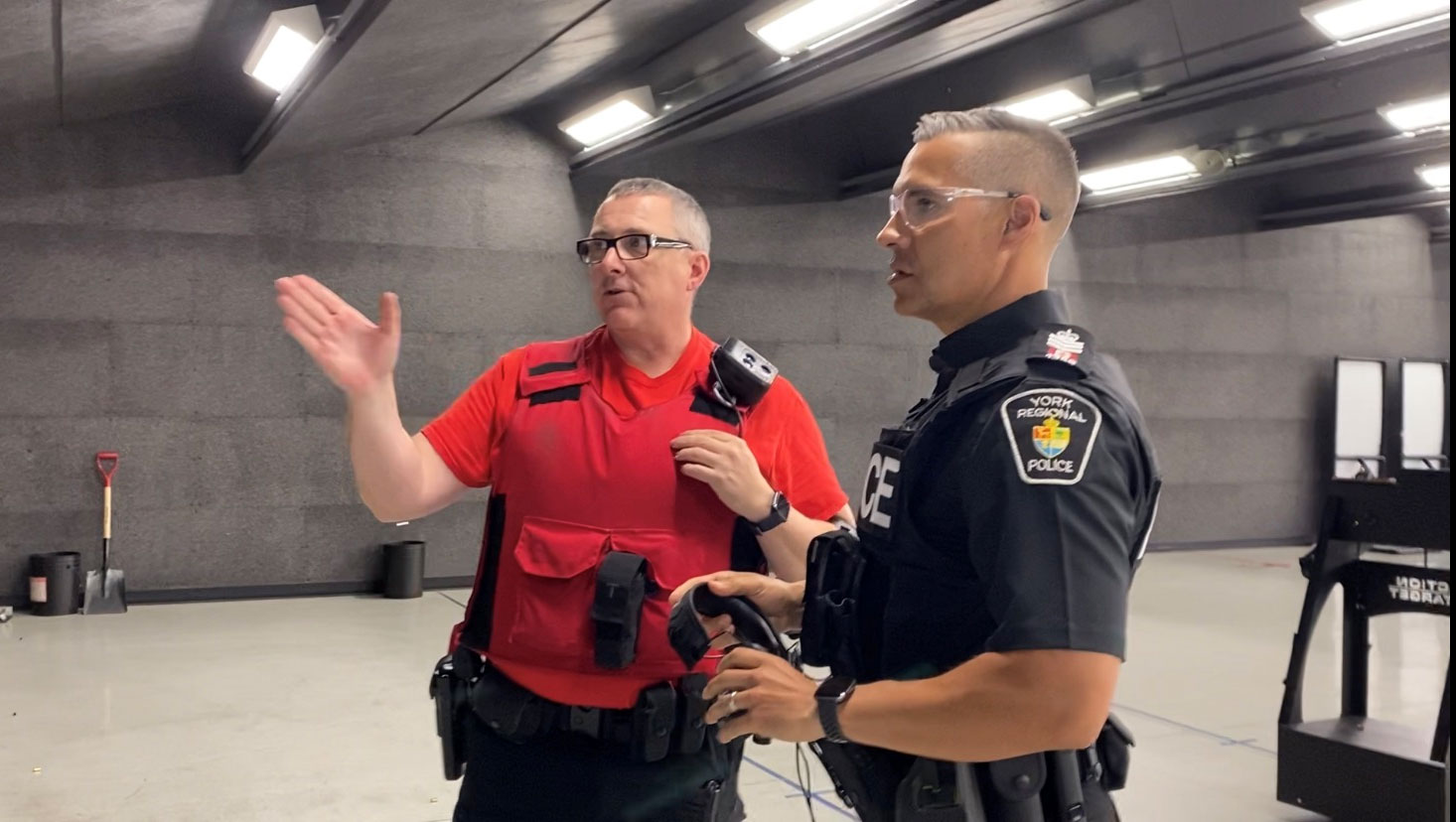 Two officers in uniforms having a conversation in the shooting range