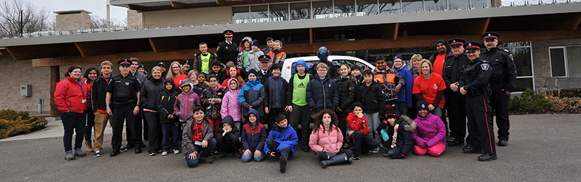 A group of officers and kids outside the safety village
