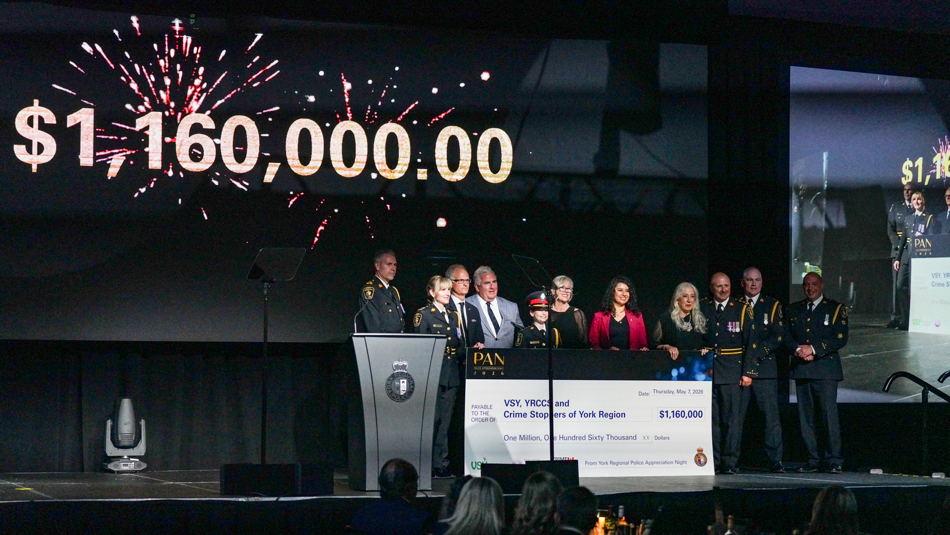 Chief Jim MacSween presents a cheque for 1.16 million dollars to beneficiaries of PAN