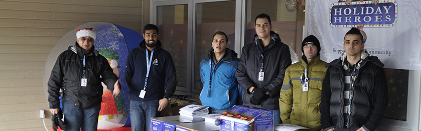 A group of volunteers standing behind a table