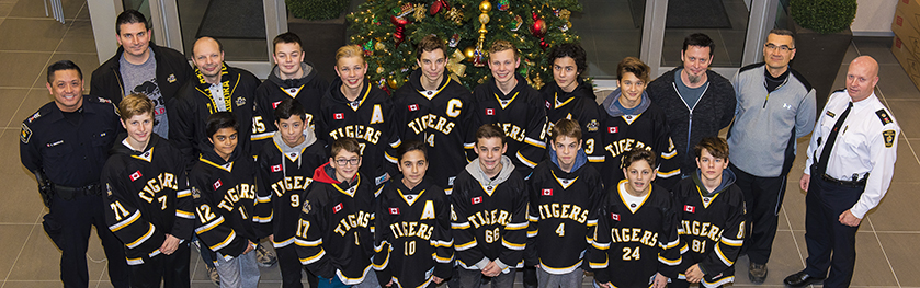 A group of officers and a teen boys' hockey team