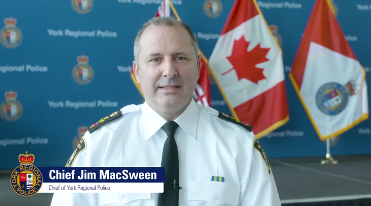 Chief Jim MacSween in front of a blue YRP backdrop