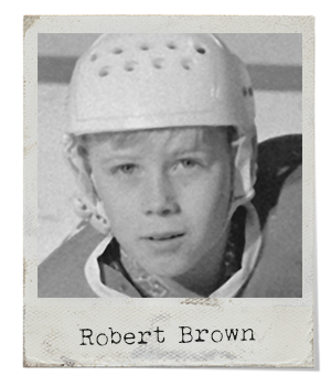 A blonde-haired boy wearing a white hockey helmet