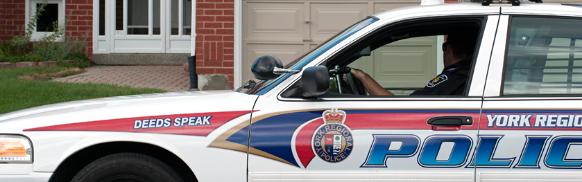 A cruiser driving by a house