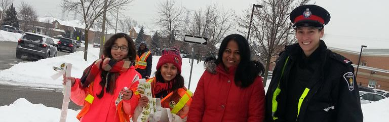 An officer with kids outside in the winter