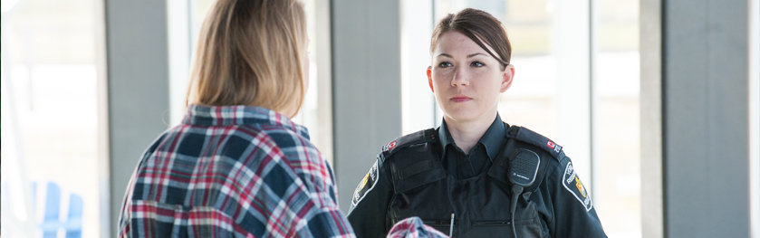 An officer talks to a girl