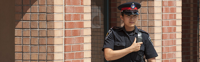 An officer reaches for her radio