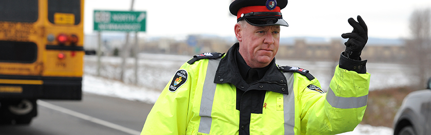 An officer points on the road