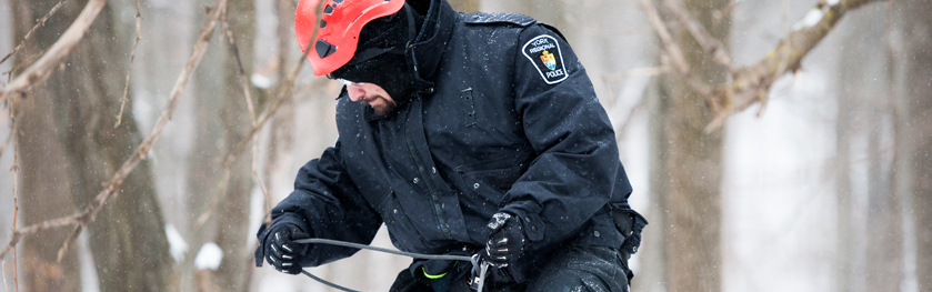 A man in a winter coat rappels