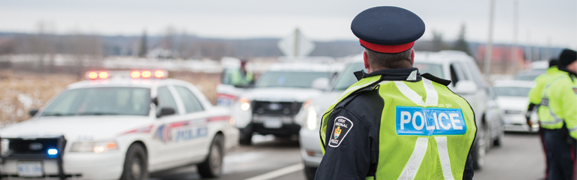 An officer wearing a vest directing traffic