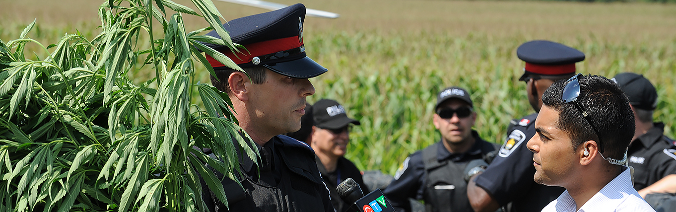 Police officer speaking to reporter.