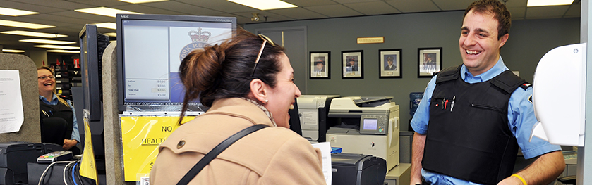 A woman talking to an officer at a police station