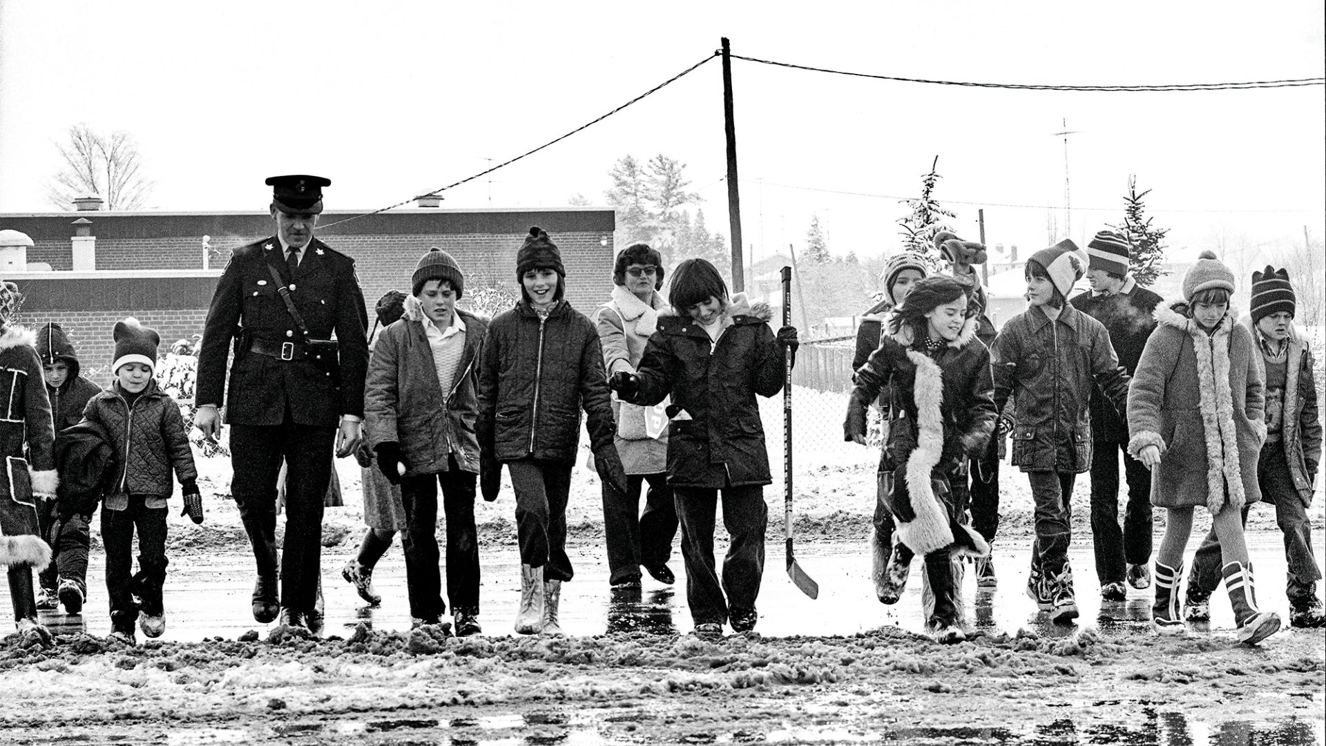 A group of kids with a police officer