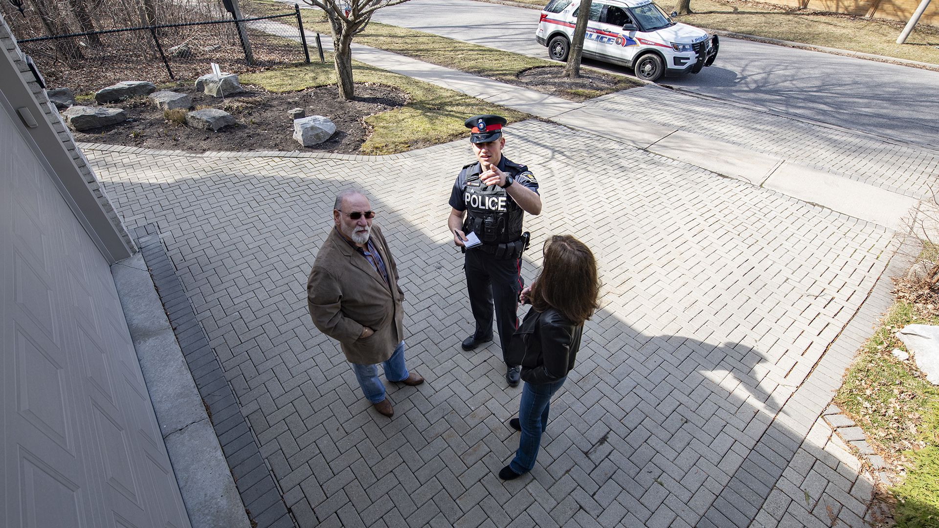 An officer and two people can be seen in security camera footage