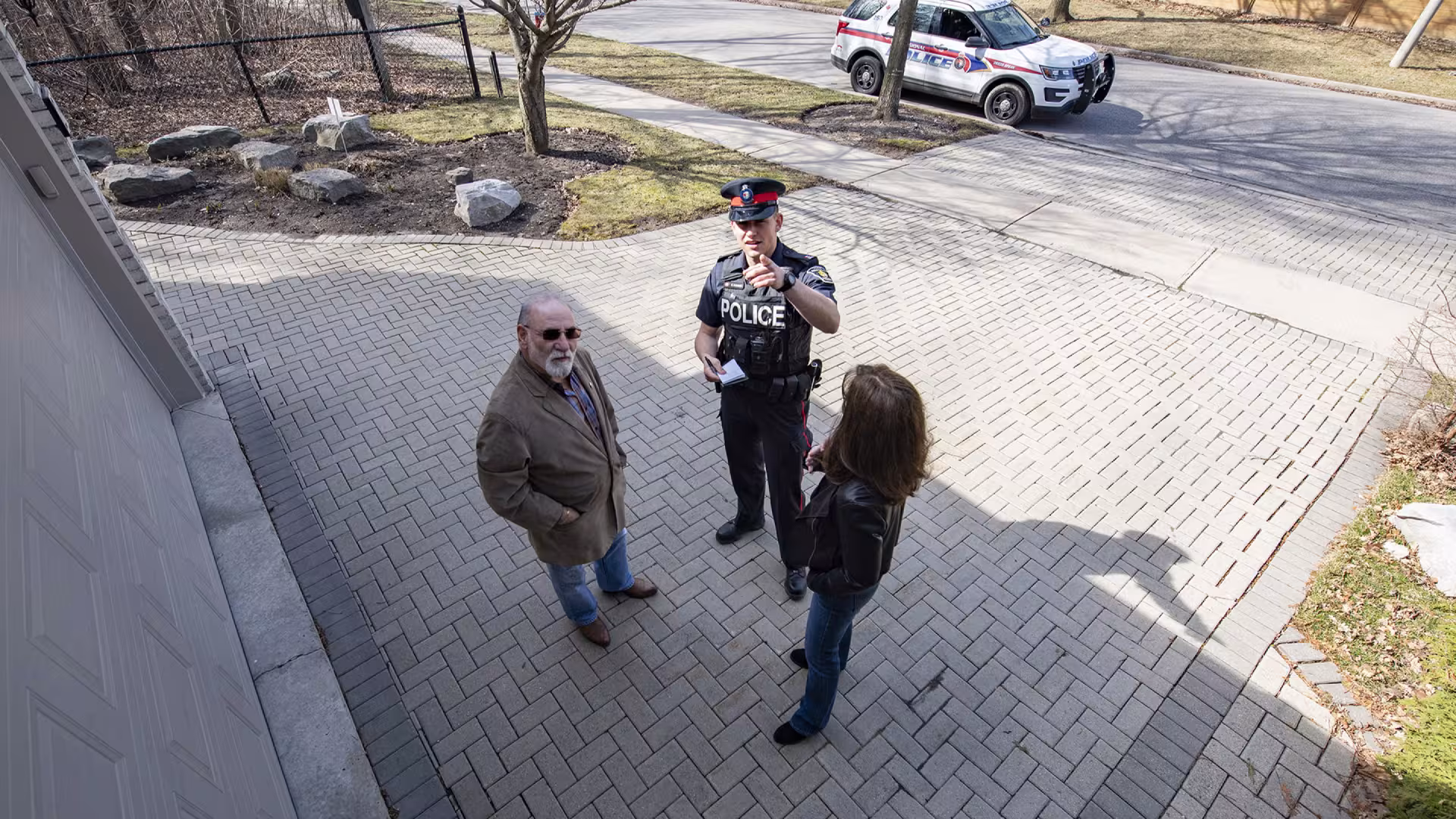 An officer and two people can be seen in security camera footage