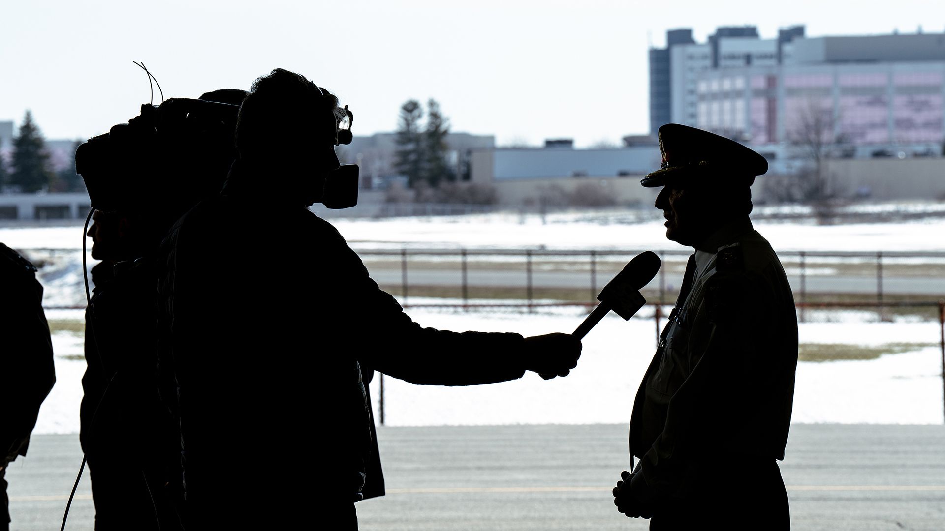 A silhouette shows Chief MacSween speaking to a camera operator.