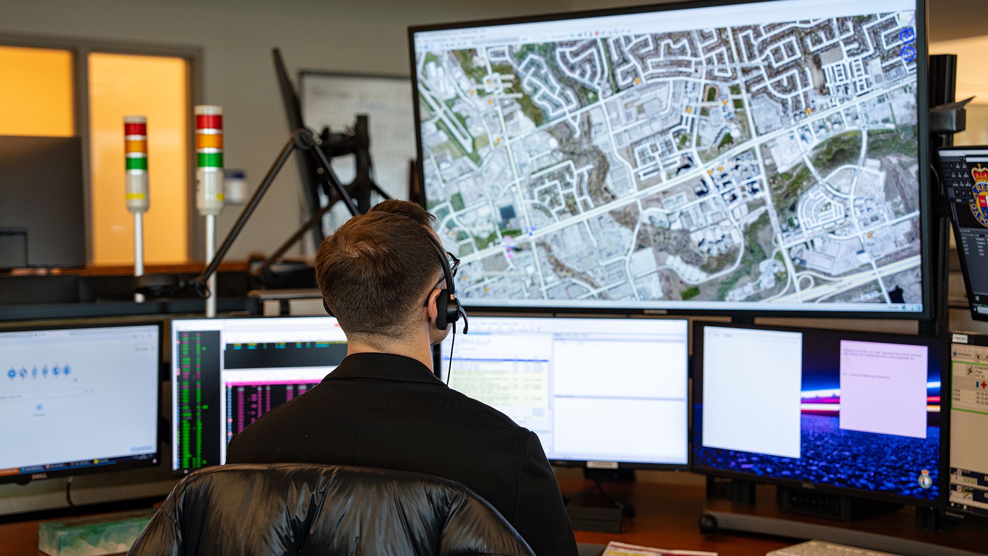 A 9-1-1 Communicator looks at a map.