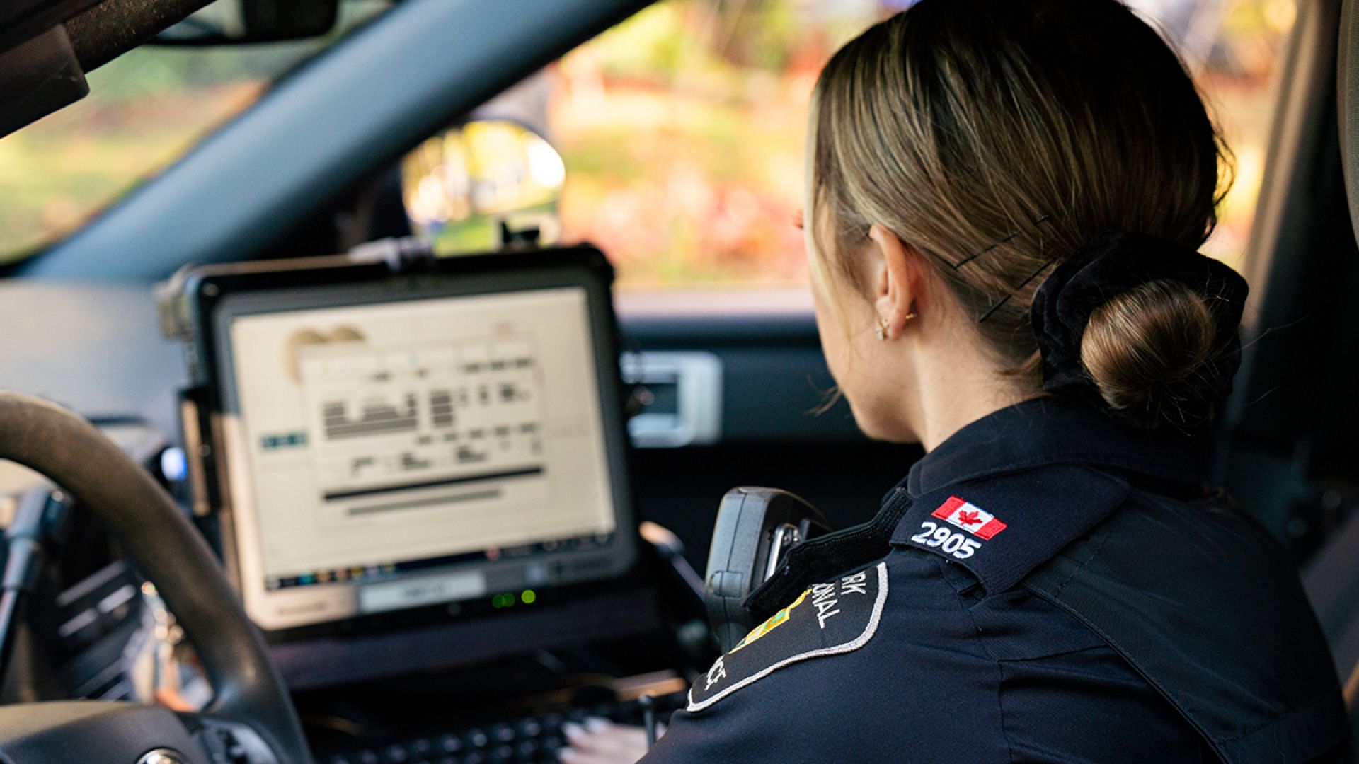 A woman in a police uniform on a mobile computer