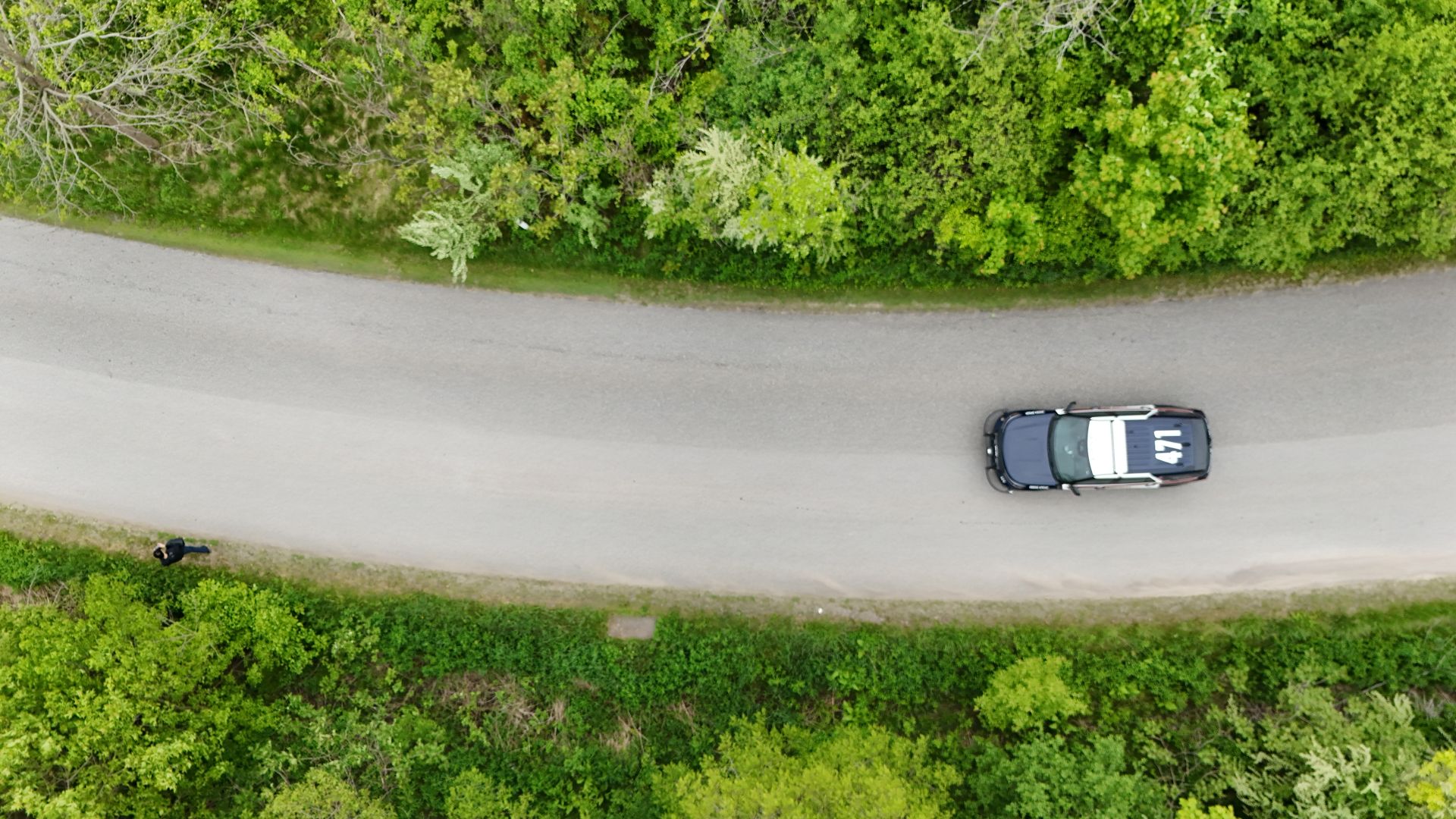 An overhead view of a police car on a rural road