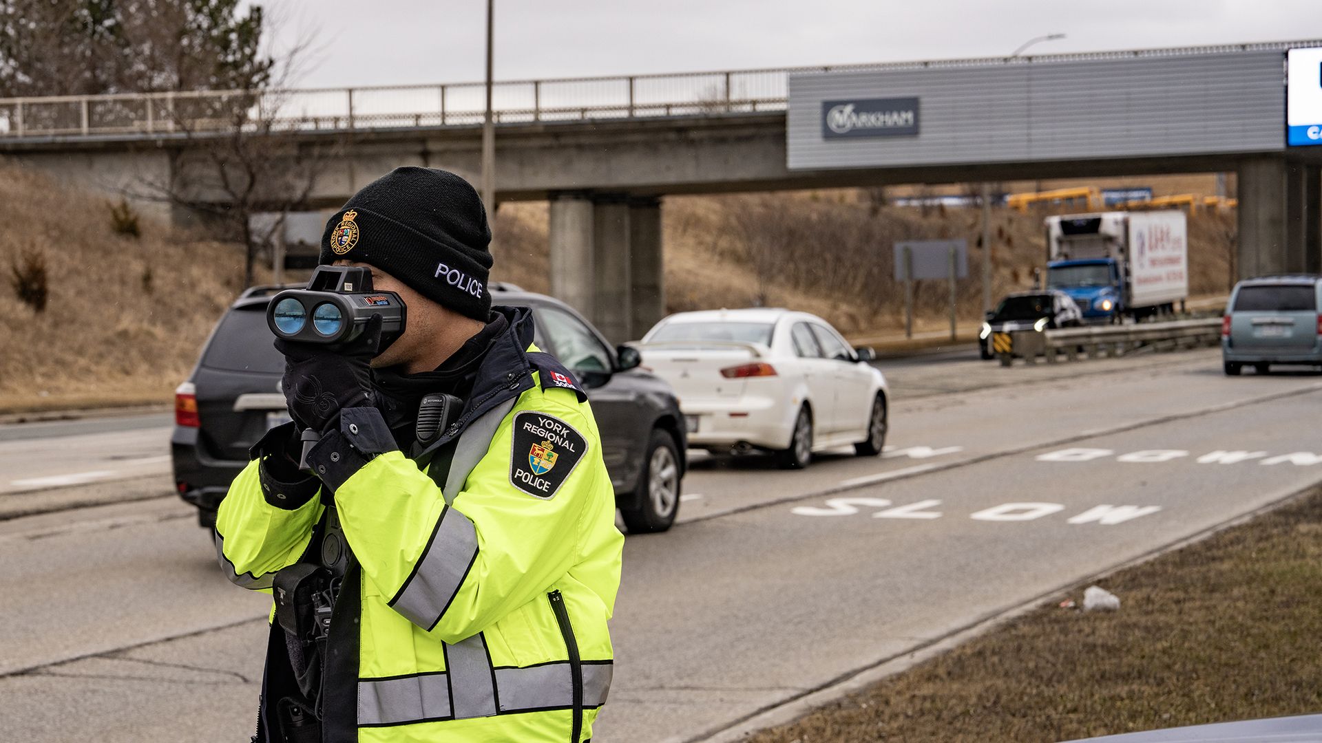 An officer conducts radar along a highway in York Region.
