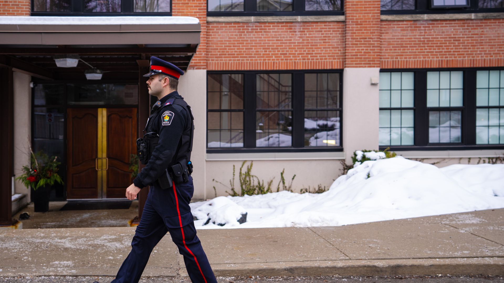 A man in a police uniform walks