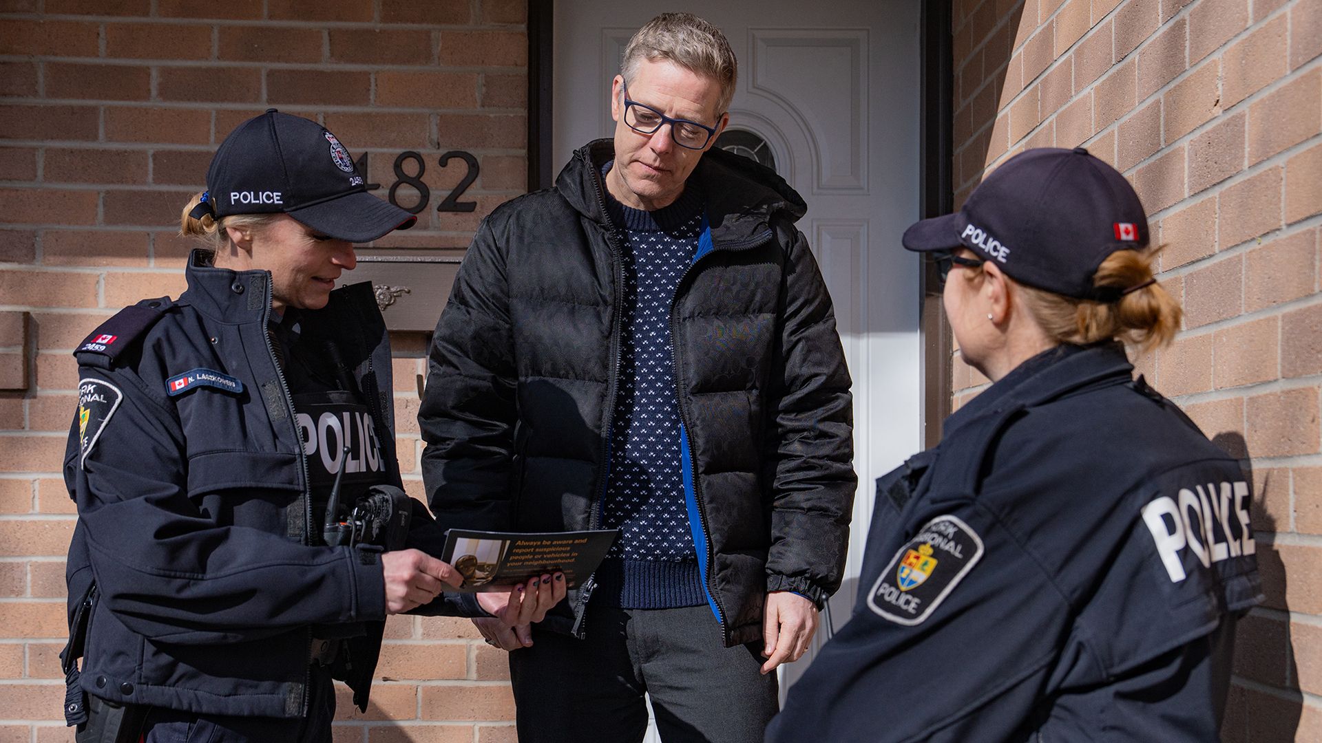 Two officers speak to a homeowner