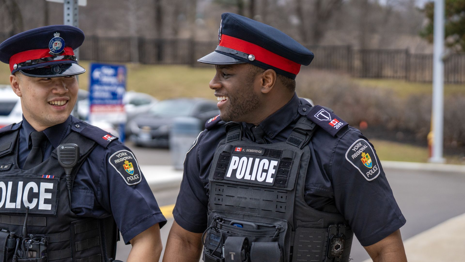 An officer smiles while walking