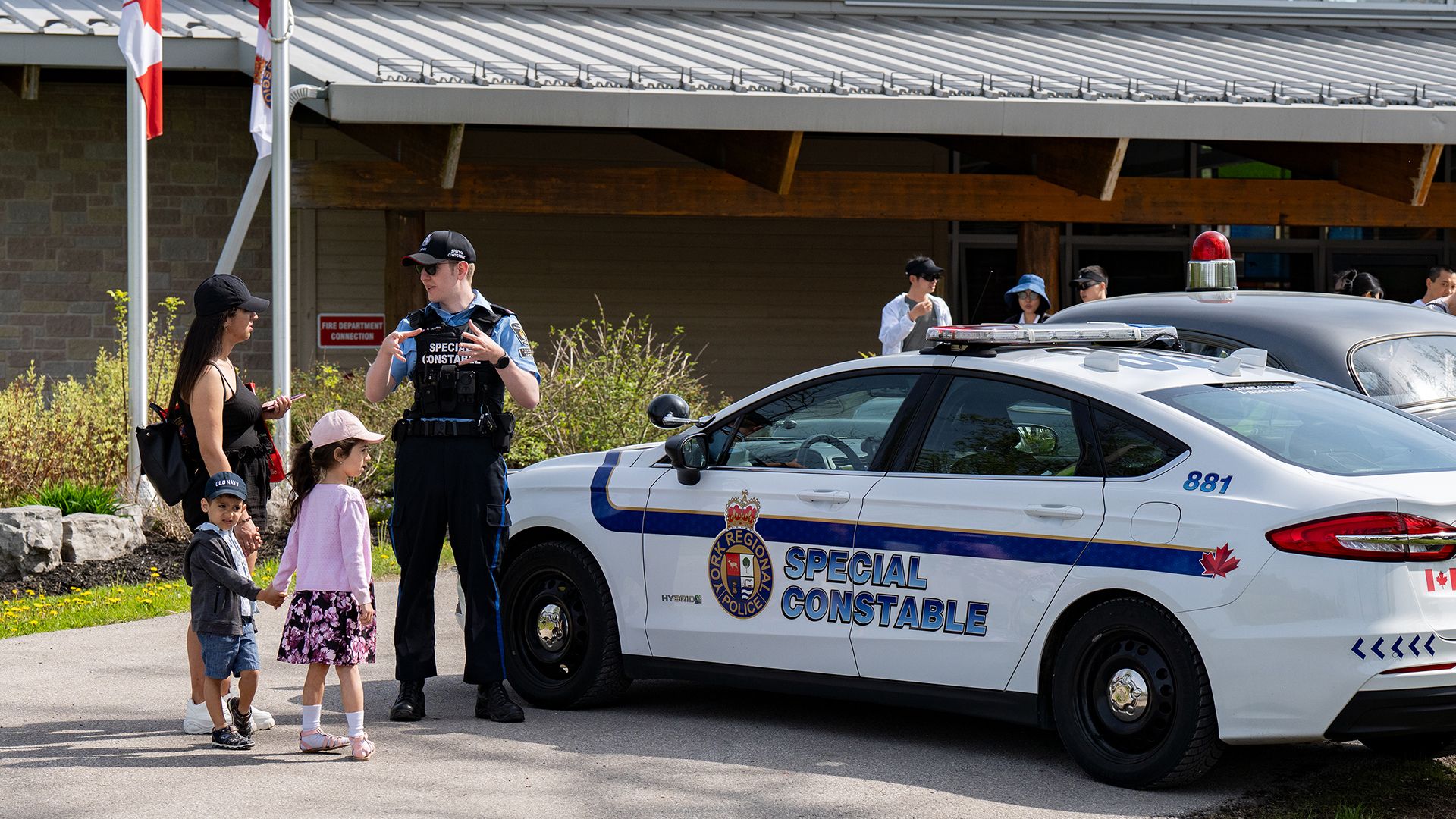 A Special Constable speaks to a woman and her children