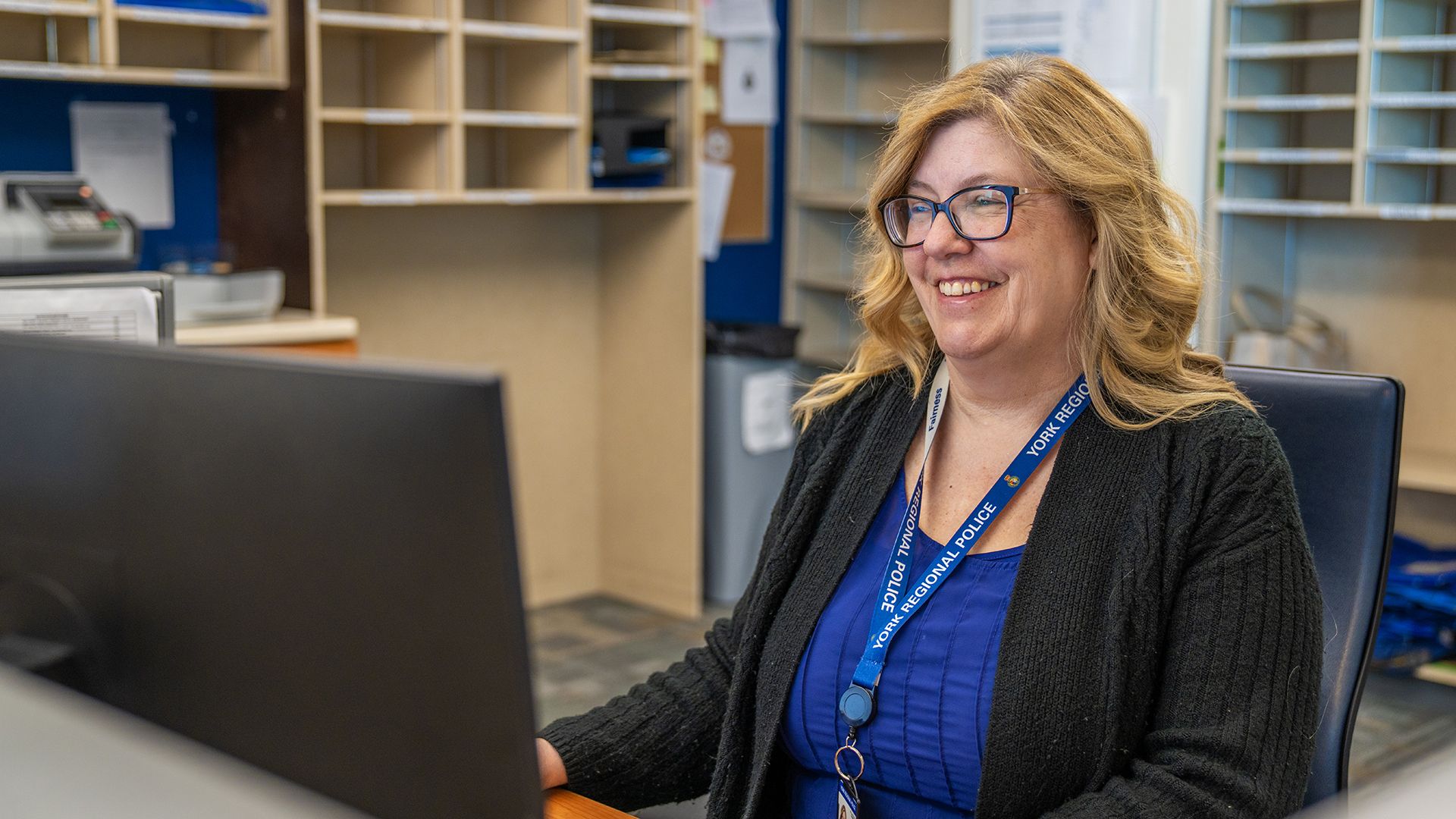 Woman smiling while using a computer