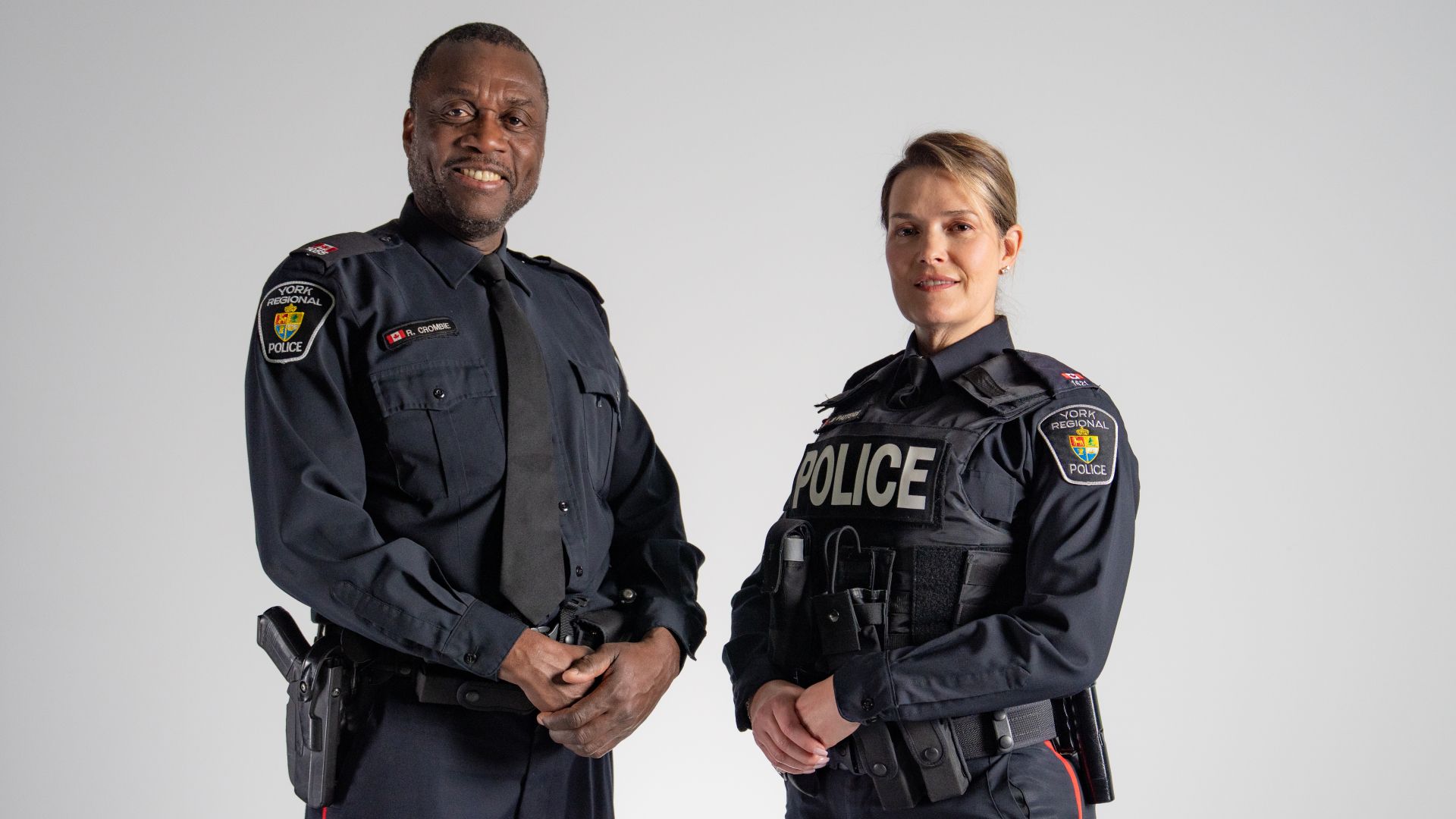 A man and a woman in police uniforms