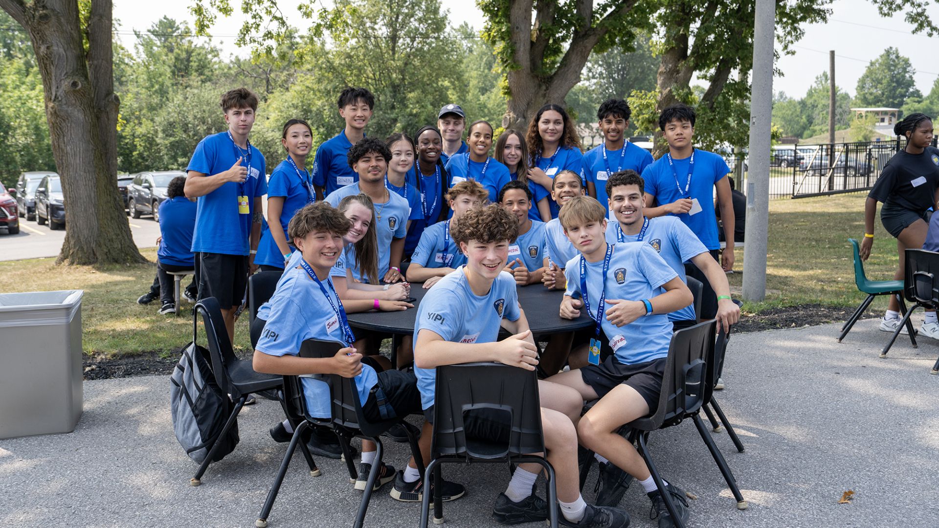 A group of teens in blue shirts