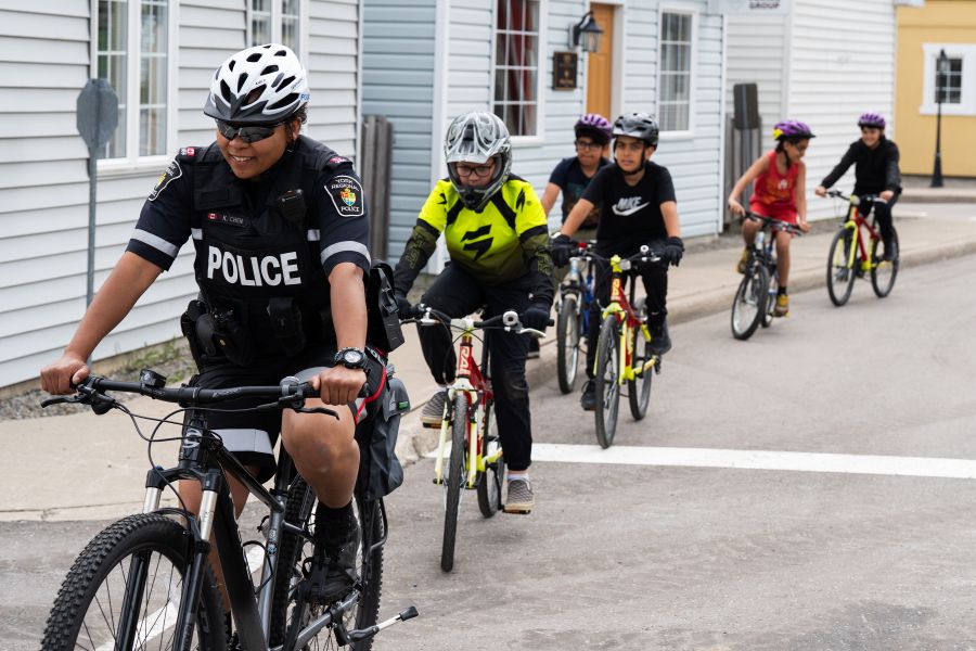 A group of kids on bikes with a police officer
