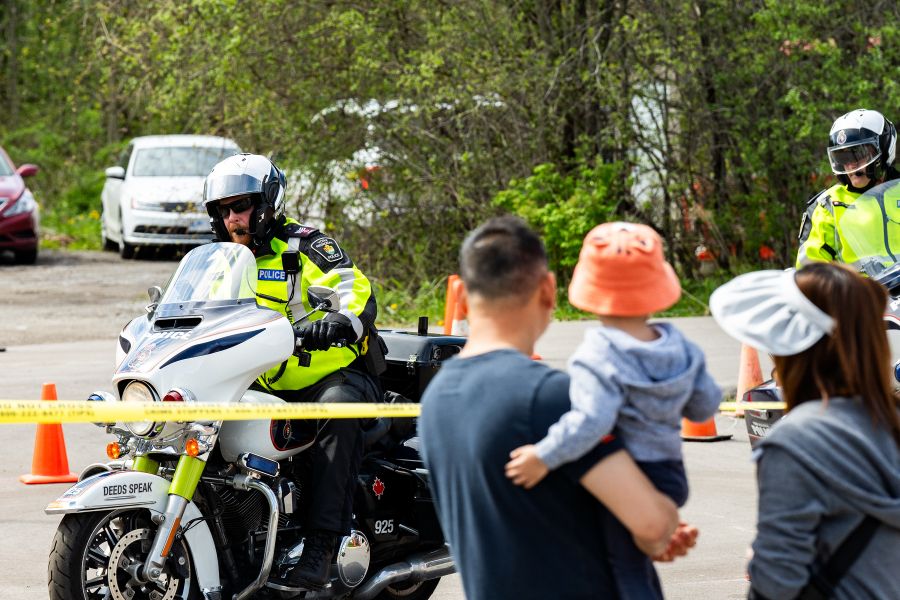 A man and child watch a police motorcycle
