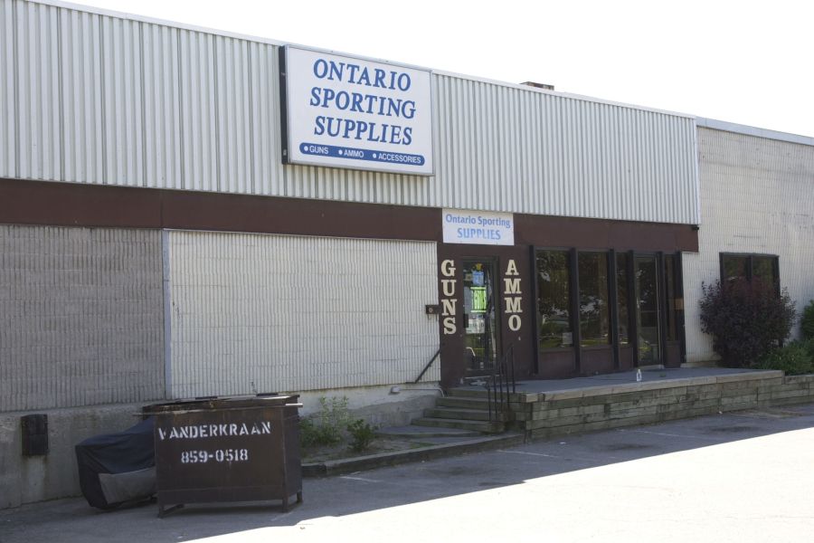Store called "Ontario Sporting Supplies" with "Guns" and "Ammo" written on the door.