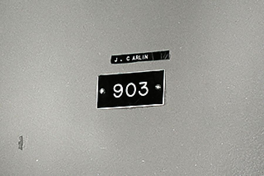 Apartment door of cold case victim, Jean Carlin, showing her name and the room number 903.