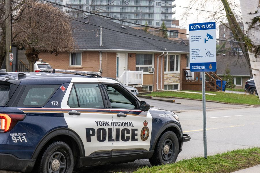 A police car next to a sign