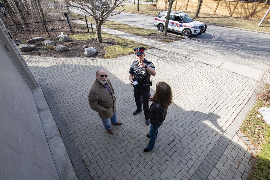 An officer and two people can be seen in security camera footage