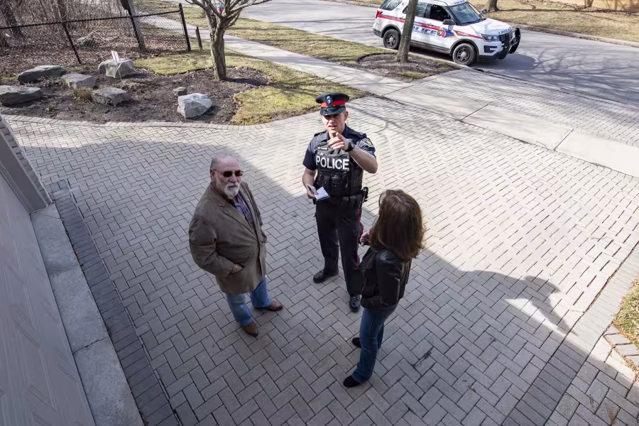 An officer and two people can be seen in security camera footage