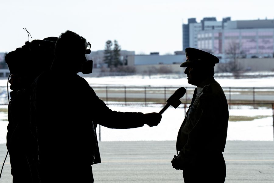 A silhouette shows Chief MacSween speaking to a camera operator.