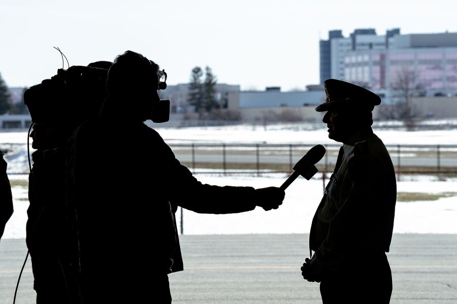 A silhouette shows Chief MacSween speaking to a camera operator.