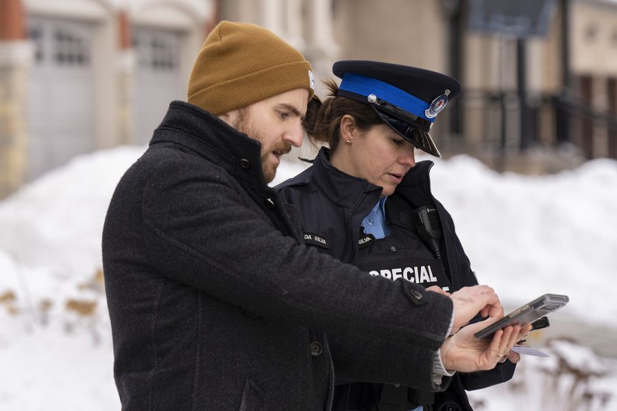 A man shows a Special Constable something on his phone