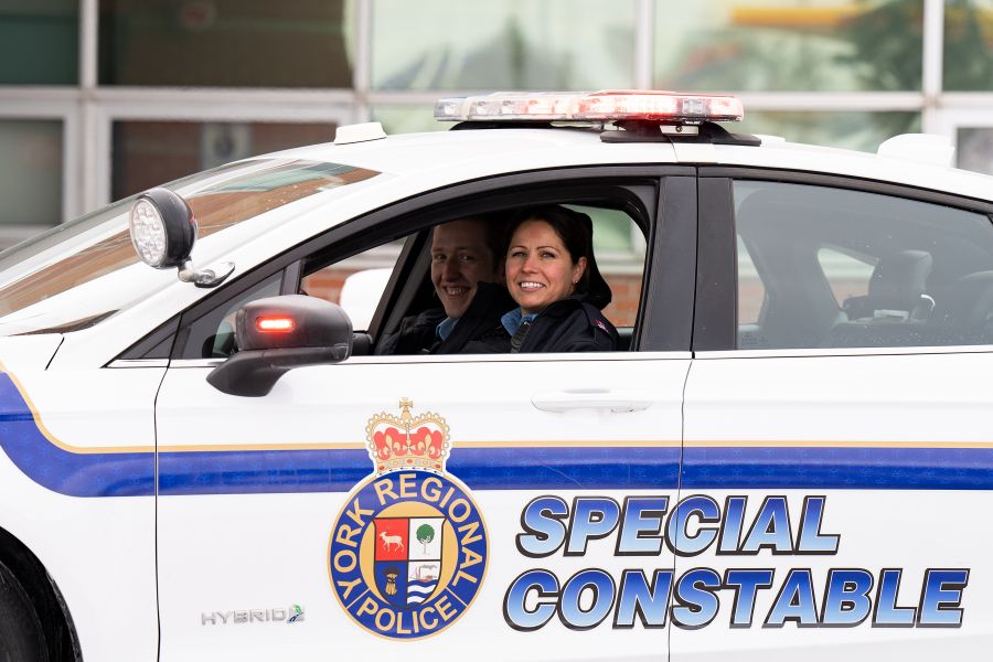 A woman in a car that reads SPECIAL CONSTABLE