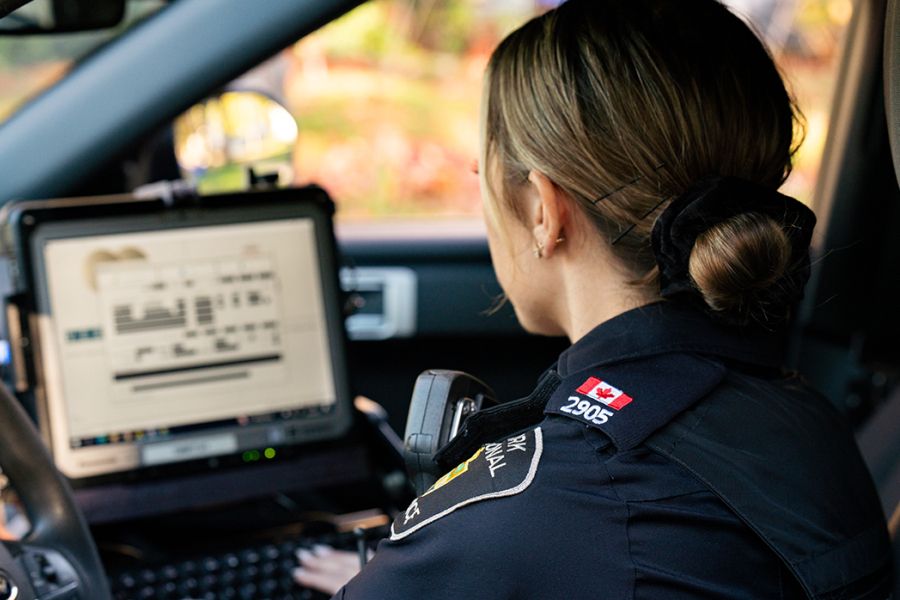 A woman in a police uniform on a mobile computer
