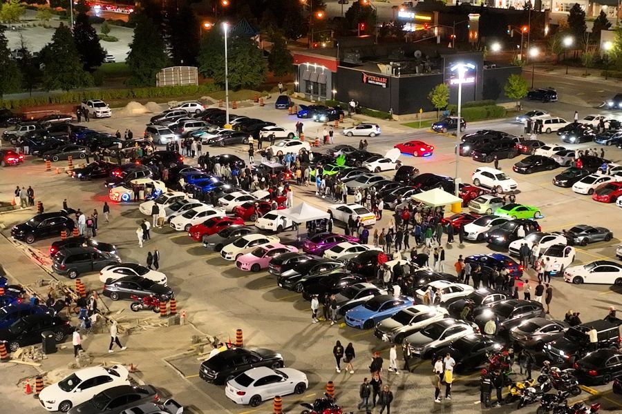 An aerial shot from Air2 shows a large car rally in a plaza parking lot