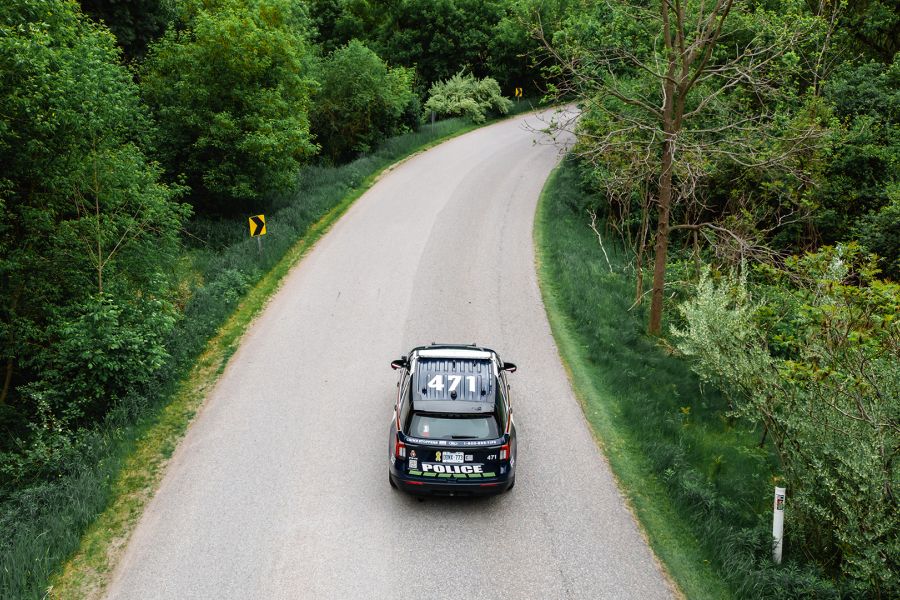 A cruiser drives down an empty road. 
